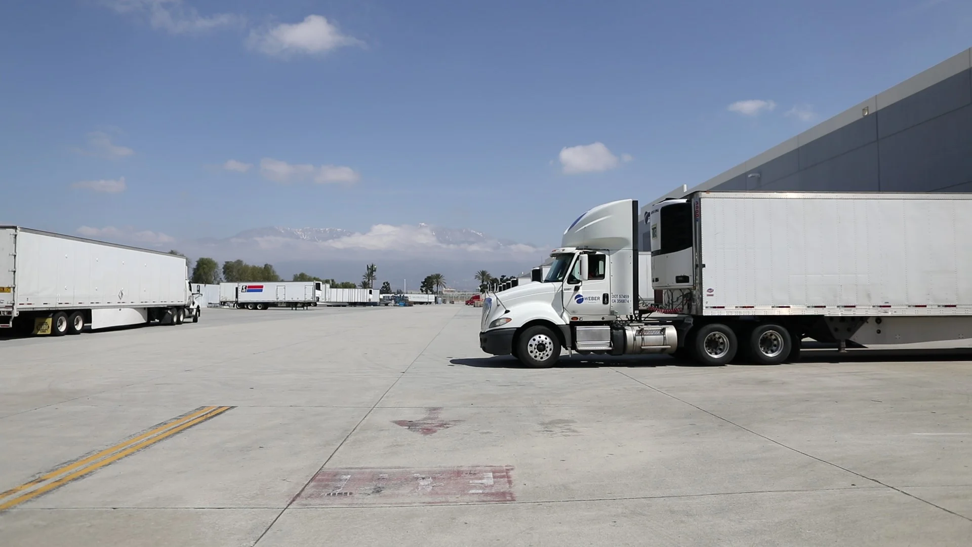 A professional truck driver beside a tractor
